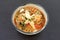 Asian spicy seafood noodle soup, instant seafood noodle soup, in ceramic bowl
