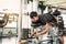 Asian sport man stretching and lifting weight by two legs when facing down for stretching muscle at fitness gym at condominium