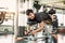 Asian sport man stretching and lifting weight by two legs when facing down for stretching muscle at fitness gym at condominium