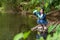 Asian student biology taking and testing sample of natural river water. Experts science women keep water for research analysis in