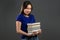 Asian student is dissatisfied wit homework books.Girl with books, she is annoyed