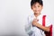Asian student kid boy wearing student thai uniform accident broken bone wearing splint arm plaster fiberglass cast covering arm in