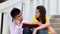 Asian Student sitting stairs at outdoor place. Couple people using book