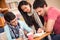 Asian student studying with classmates in classroom