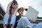 Asian students sitting on step are excited and stressed and disappointed after check exam results in computer laptops,