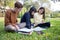 Asian students use notebook computers and tablet to work and study online in the garden at home