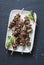 Asian style grilled beef skewers on a dark background, top view. Delicious appetizer, tapas