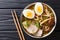 Asian style soup with udon noodles, pork, boiled eggs, mushrooms