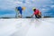 Asian teamwork of Roofer using electric drill nail gun installing PU foam roof sheet under construction. Working at height