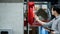 Asian technician checking fire hose reel