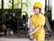 Asian technician girl with yellow uniform and helmet use polishing machine for wood working