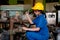 Asian technician or turner girl use the screw  machine to drill the product in the workplace