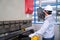 Asian technician worker wearing a safety suit Setting Hydraulic Press Break Machine and Prepared Sheet Metal Shearing in