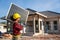 Asian technicians wearing safety clothing carry solar cells to install on the roof of a house at construction site. Concept of