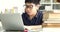 Asian teen boy waring eyeglass and used laptop computer at home, cute boy doing your homework with serious face.