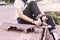 Asian Teen Girl With Skateboard style in outdoors skate park street with dark vintage tone style