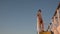 Asian teen standing on top of blue stair with yellow stripe