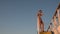 Asian teen standing on top of blue stair with yellow stripe