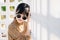 Asian teen waring round sunglasses in vintage style dress summer fashion collection model portrait