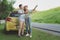 Asian teenage couples parked on the roadside, search for tourist spots on the map.