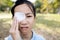 Asian teenage girl cover with blindfolded bandaged eye to protect against dust after surgery from hordeolumstye infection or