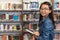 Asian teenage girl with eyeglasses in school library