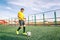 Asian teenager on a football field with a ball, sports and enter