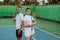 Asian tennis athletes standing back to back