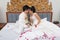 Asian Thai Bride and Groom on a Bed in Wedding Day