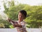 Asian Thai cute kid holding water hose with water splash.