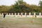 Asian thai father training and playing football or soccer with son at playground on yard in public garden park in Thailand