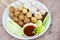 Asian Thai food grilled meatballs fishball and porkball with spicy sauce, Meatballs on skewers on white plate and fresh vegetables