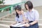 Asian Thai high schoolgirls student couple in school reading and studying