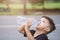 Asian thai kids drink water in park