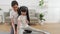 Asian Thai mother and daughter practice yoga on living room floor together.