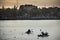 Asian thai people and foreign travelers playing and practice sports paddle boat canoe in pond in dusk time of Nong Prajak