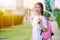 Asian Thai teenager school girl with education bag standing outdoor happy and smile