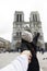 Asian thai woman lead someone by the hand and hold at Cathedrale Notre-Dame de Paris