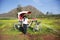 Asian thai woman travel and posing with classic vintage bicycle rickshaw at outdoor with view landscape and mountain