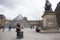 Asian thai woman travel and posing for take photo at courtyard of Louvre Pyramid at Musee du Louvre