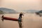 Asian,Thailand fisherman cacth fish on the wooden boath in meko