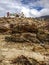 Asian Tibetan Buddhist prayer flags on the rocky hill in rural natural background. Nature Travel, tradition, culture and religion