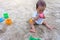 Asian toddler baby thai girl playing with sand