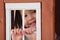 Asian toddler smiling through playhouse window