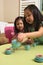 Asian toddlers playing with toy tea set