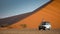 Asian tourist on camper car near sand dune