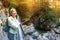 asian tourist girl walk along a hinged iron trail along sheer cliffs in the canyon of the Pollat river in the Bavarian Alps