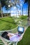 Asian tourist lying on net using laptop at beach