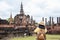Asian tourist woman take a photo of ancient of pagoda temple thai architecture at Sukhothai Historical Park,Thailand. Female
