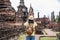 Asian tourist woman take a photo of ancient of pagoda temple thai architecture at Sukhothai Historical Park,Thailand. Female
